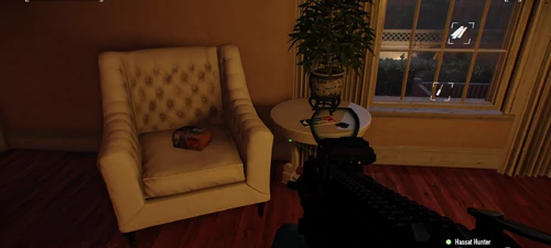 20. On a chair at the back of the second level in the back