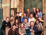 Chica and the Sprout crew on the Sesame Street set with Cookie Monster