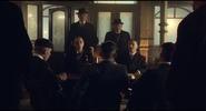 Billy Kimber and his assistant Roberts meeting with the Peaky Blinders Gang in Episode 1.2.