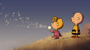 Charlie Brown watches his sister Sally Brown blowing dandelion