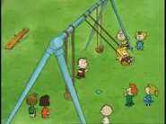 Janice laughs happily on the swings as everyone looks on smiling.