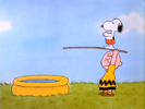 Snoopy prepares to dive into the pool while Charlie Brown holds the plank