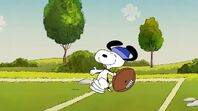 Snoopy does the happy dance after catching the football from Peppermint Patty