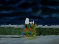 Snoopy sleeps in his doghouse after he lights up with a Christmas decoration