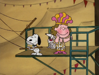 Polly blushes after Hugo the Great Snoopy kisses her cheek before trapeze act