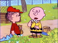 Charlie Brown holding a flower