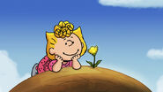 Sally Brown admires a dandelion flower