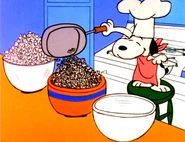 Snoopy serving popcorn for dinner.