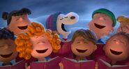 The Peanuts gang in a chorus sing the classic song "Christmas Time Is Here" from A Charlie Brown Christmas.