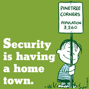 Image (non-canonical) of Linus hugging a sign that says Pinetree Corners, pop. 3260.