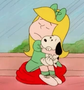 Lila feeling sad that she has to remove Snoopy as she hugs him.jpg (115 KB) Lila feels sad because she has to remove Snoopy since her apartment does not allow dogs there as she hugs him in Snoopy's Reunion.