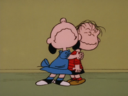 Lucy hugs Linus after she cried about what Linus said to her in A Charlie Brown Celebration
