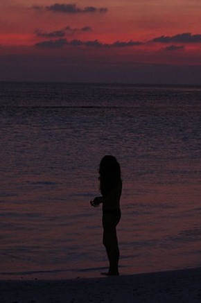 Woman at the beach, sunset