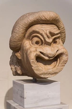 Comedy mask, Athens, Greece,  This could be the "ruler slave", the "first slave" a character of the New Comedy. 2nd-century BCE. Courtesy Wikimedia Commons.