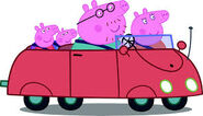 Peppa with George Pig, Mummy Pig and Daddy Pig in the Red Beetle