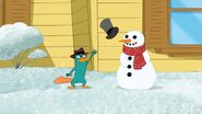 Perry throws a hat onto the snowman