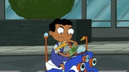 Baljeet, angry, using the bike's handle to straighten the bill.