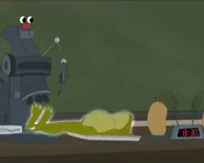 The needles trigger a chain reaction between a potato clock and a frog, causing the latter to kick the dish