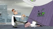 Doofenshmirtz sticks one end of the mop on the -inizor and uses the unconscious Rodney as a fulcrum to make the -inizor fall off the roof.