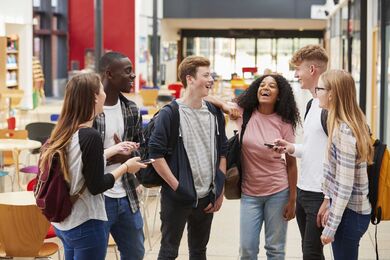 A group of laughing teenagers.