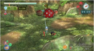 A Red Pikmin using a bomb rock on a Red Bulborb in Pikmin 3.