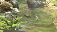 Winged Pikmin flying over water.