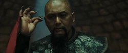 Sao Feng holds a Piece of Eight coin.