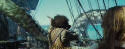 Lejon grabs Elizabeth Swann's musket only to be grabbed by the Kraken.
