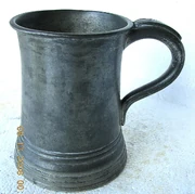 A rum tankard, made out of metal to withstand a night of                                        drunken revelry.