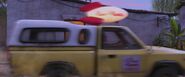 The Pizza Planet Truck drives past the Rivera house, during the montage of Abuelita enforcing the family's ban of music.