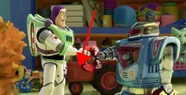 A toy tractor similar to the Tractors from Cars appears behind Buzz and Sparks.