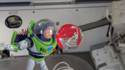 Toy Buzz Lightyear making a gravity experiment in "The Science of Adventure (with NASA)".