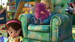 A miniature toy car of Lightning McQueen appears behind the girl playing with stuffed animal toys