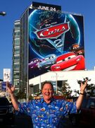 John Lasseter in front of a building advertisement in Los Angeles[45]