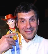 A Woody doll being held by Woody's Italian voice actor Fabrizio Frizzi