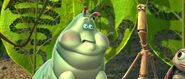 Heimlich turns a sickly greenish gray after seeing the mural of him being sliced in half by the grasshoppers