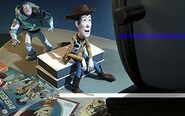 A promtional image of Buzz watching Woody watch Woody's roundup