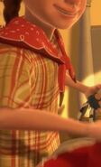 Emily picks up Jessie and puts her cowboy hat on