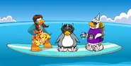 Kenzie, Gizmo, Wingman, and Charlie on a surfboard.