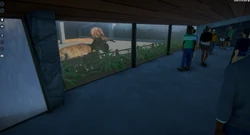 An amber Nasutoceratops near a modular viewing area.