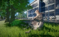 An Equine Lambeosaurus resting near a fence with an Animal Nursery in the background.