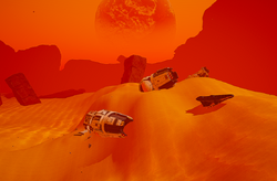The wreck of the Cinitat-II is nearly completely buried under a sand dune south of the mountain.