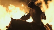 Koba arms himself with twin machine guns to make good his battle.