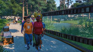 A group of guests walking past a grizzly bear enclosure