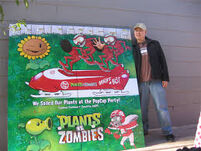 George Fan standing beside a Plants vs