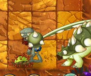 A Cactus planted in the third column from the right disabling an Ankylosaurus's attack (the zombie is only pushed on top of the Cactus)