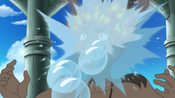 Popplio fires Bubble Beam to douse flames on Kiawe's hair