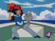 Ash takes the spherical object from Spoink