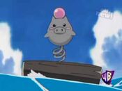 A Spoink floats on a log