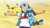 Riolu laying next to Ash and Pikachu